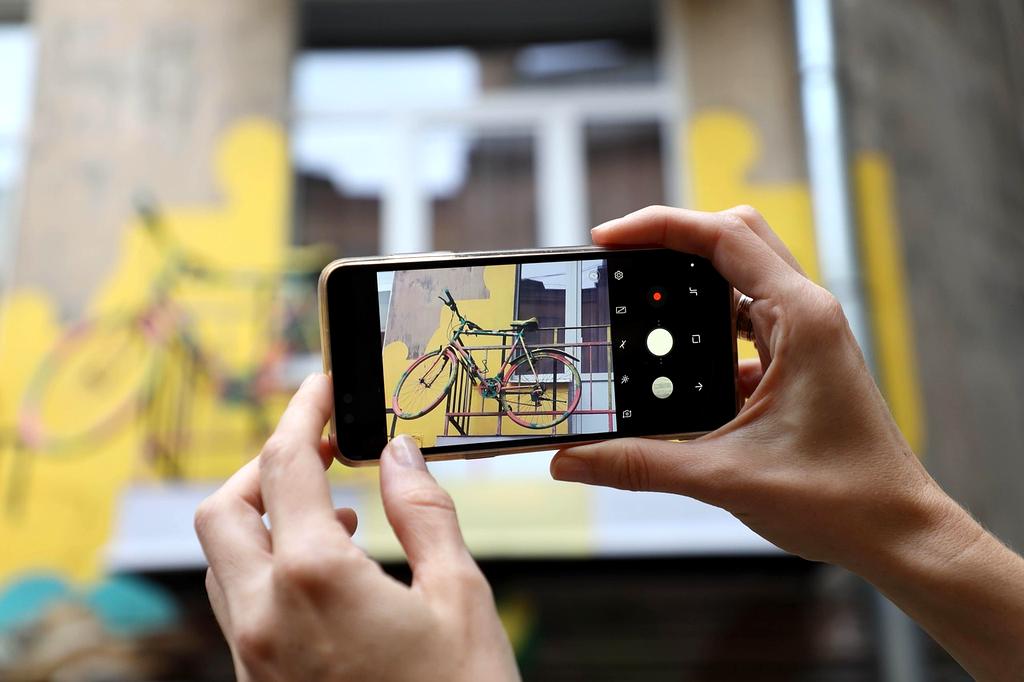 Smartphone displaying multiple travel app icons on a vibrant background